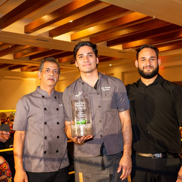 Three men, two in chef coats and one in a black shirt, proudly display a "People's Choice Best Salsa" award.