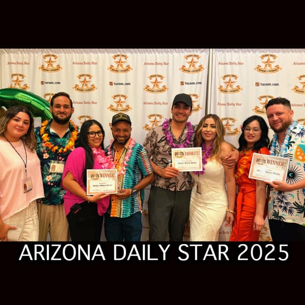 Amelia's Mexican Kitchen team proudly holding "2025 Winner" and "Favorite" awards from Arizona Daily Star.