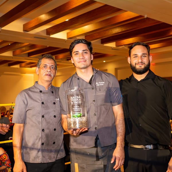 Three men, including Chef Jose Contreras, proudly display the "People's Choice Best Salsa" award.